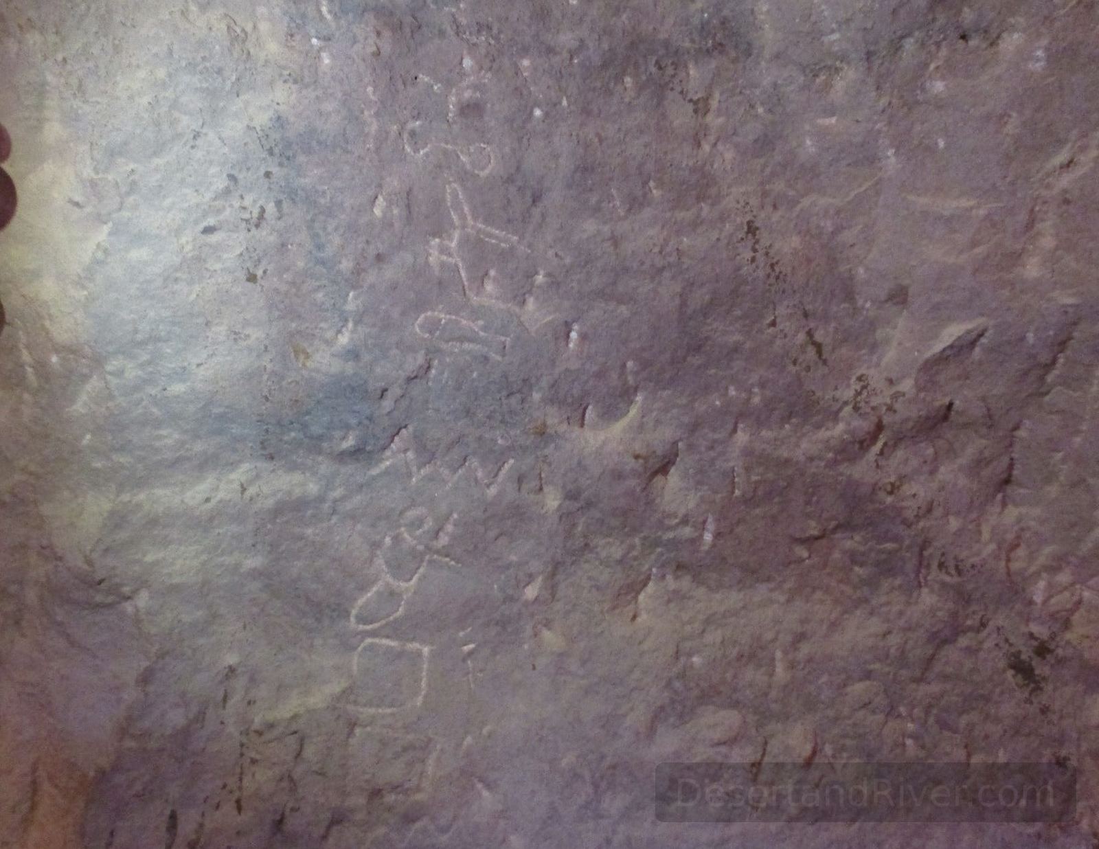 Rock surface inside Magharet el Teleha cave in South Sinai showing faint Proto-Sinaitic and hieroglyphic inscriptions.