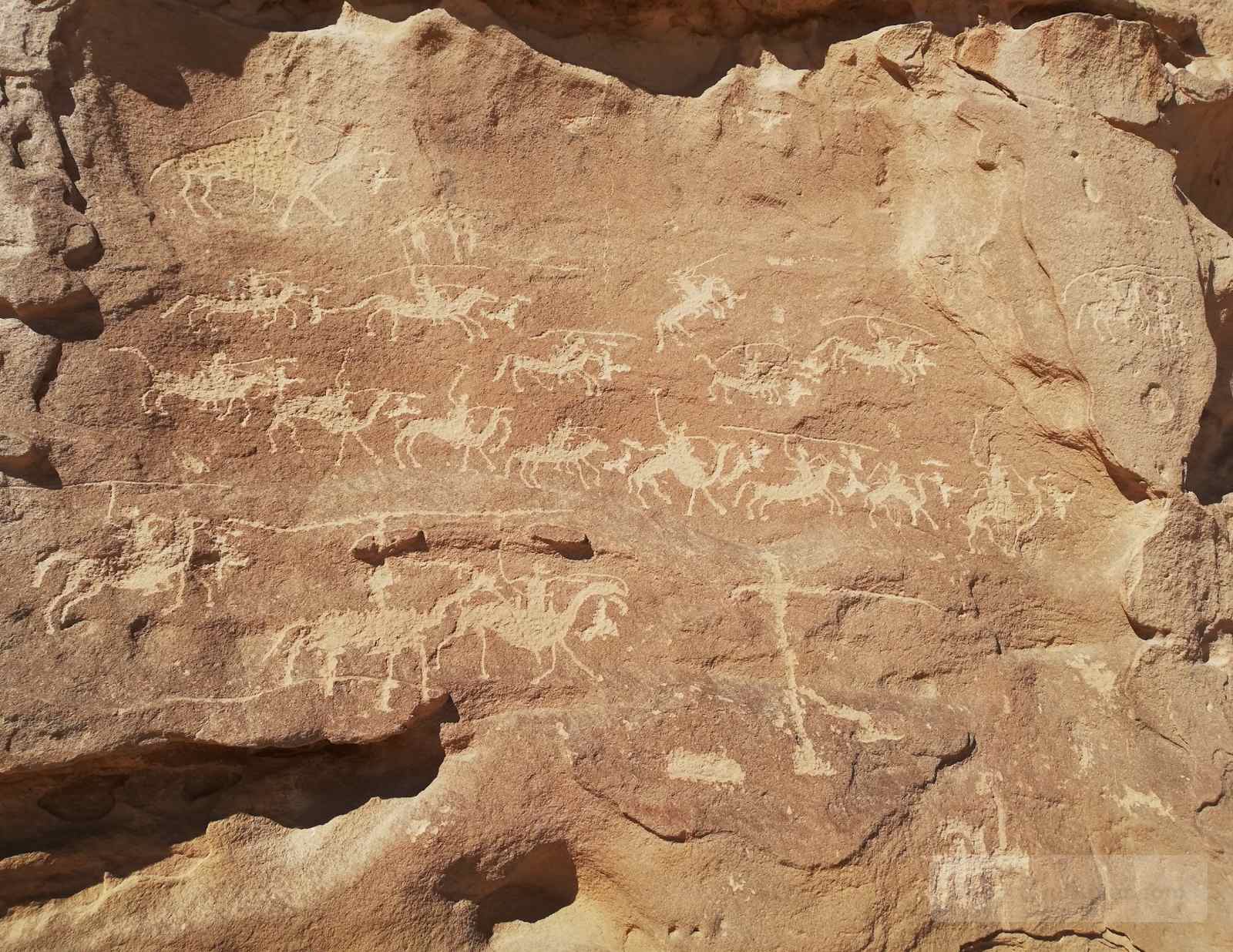 Nabataean rock carvings on sandstone showing figures and animals, known as the Nabataean War Scene in South Sinai.